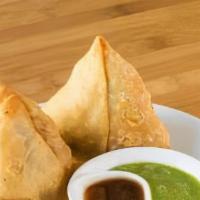 Vegetable Samosa · 2 pieces. Deep-fried, flaky pastry filled with smashed potatoes, peas, and Indian spices.