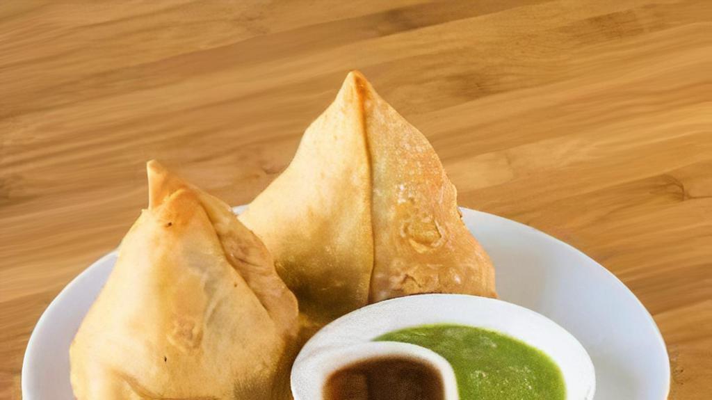 Vegetable Samosa · 2 pieces. Deep-fried, flaky pastry filled with smashed potatoes, peas, and Indian spices.