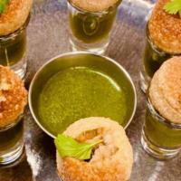 Pani Puri Shooters · 6 pieces. Small round hollow puri filled with spiced potatoes and chickpeas served with flav...