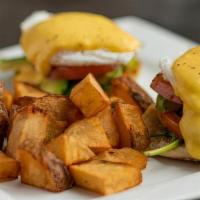 Eggs Benedict · English muffin, ham, poached eggs, hollandaise, green onion, fried potatoes.