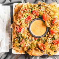 Nachos · Black beans, jack and cheddar cheese, roasted corn pico, pickled jalapeño, green onion, chop...