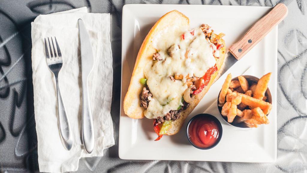 Philly Style Cheesesteak · Hatch chili, caramelized onion, and provolone on a hoagie roll.