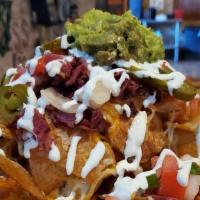 Irish Nachos · Fried potato chips, smothered in melted cheese, corned beef, sour cream, pico de gallo, guac...