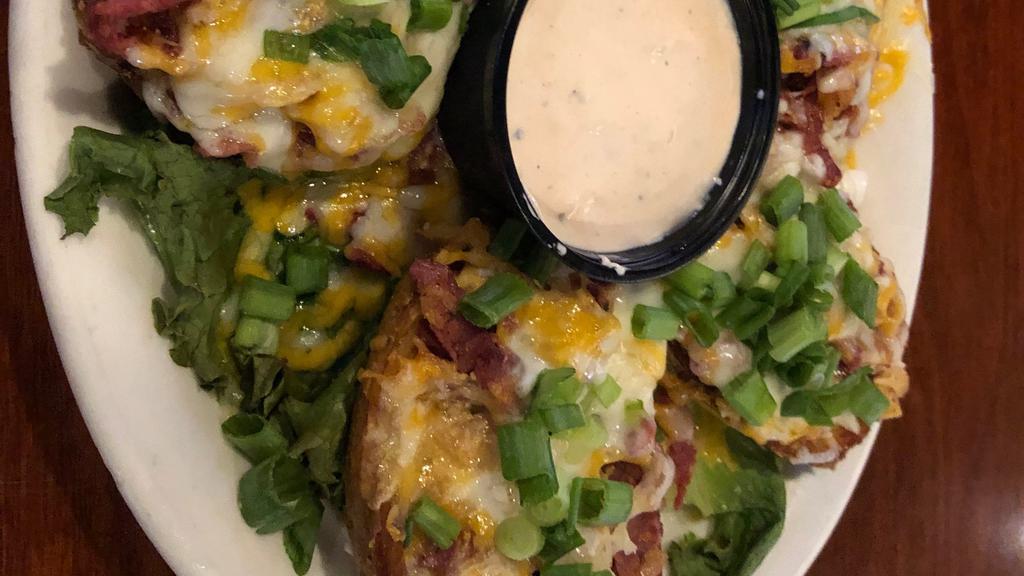 Reuben Potato Skins · Fried potato boats filled with corned beef, sauerkraut, cheddar and Swiss cheese & thousand island sour cream.