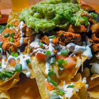 Beeg As Yer Head Nachos · Tortilla chips covered in cheddar & jack cheese, jalapenos, tomatoes, onions, sour cream, sa...
