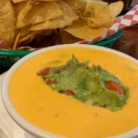 Smothered Leprechaun · A pile of our guacamole smothered in spicy queso sauce. Served with tortilla chips.