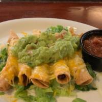 Taquitos · Five hand rolled tacos filled with shredded beef brisket topped with cheddar cheese and guac...