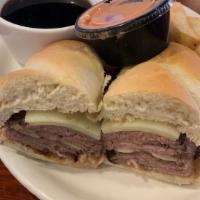 French Dip · Thinly sliced roast beef and Swiss cheese on a hoagie roll served with warm au jus.