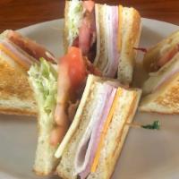 Club Sandwich · Hand sliced ham, turkey, cheddar and Swiss cheeses, bacon, lettuce and tomato on triple-deck...