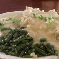 Redneck Dinner · A crispy chicken fried steak served with creamy mashed potatoes, country gravy and green bea...