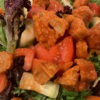 Spicy Tiger Salad · Our vegan wings, tossed in traditional buffalo wing sauce, lettuce, cucumbers, tomatoes and ...