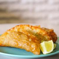 The O.G. Empanada · The Original G of Empanadas! Our Signature house Soy Picadillo braised in tomato with salty ...