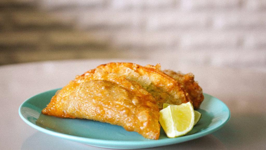 The O.G. Empanada · The Original G of Empanadas! Our Signature house Soy Picadillo braised in tomato with salty Spanish olives and fried to bubbly golden perfection!