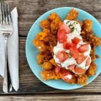 Loaded Tatertots · Tots topped with house picadillo, sour cream, diced tomat, and Violife cheddar