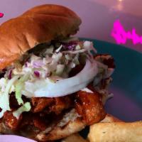 Backyard Getty Sando · Marinated BBQ guava soy curls topped with raw onion and a citrus mojo coleslaw between a pub...
