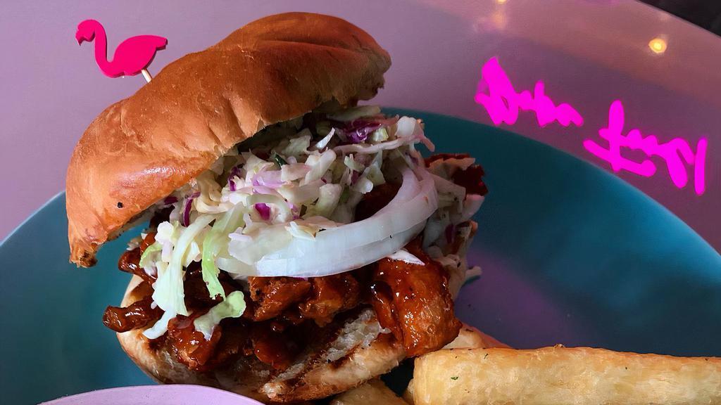 Backyard Getty Sando · Marinated BBQ guava soy curls topped with raw onion and a citrus mojo coleslaw between a pub bun.
