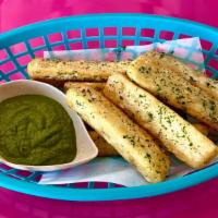 Yuca Fries · Delicious Yuca Fries with our House Cilantro Sauce.