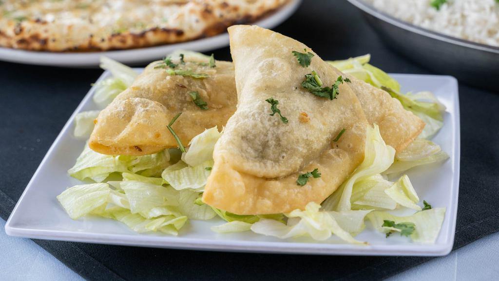 Vegetable Samosa (2) · Crisp pastry filled with potatoes, deep-fried.