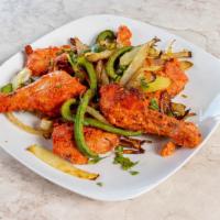 Tandoori Chicken · Chicken marinated in yogurt and spices and roasted on skewers in clay oven.