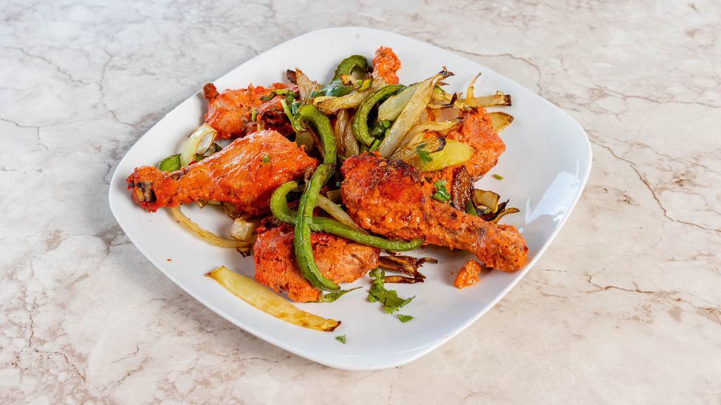 Tandoori Chicken · Chicken marinated in yogurt and spices and roasted on skewers in clay oven.