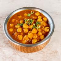 Chana Masala · Chickpeas cooked with tomato curry sauce and a blend of spices.