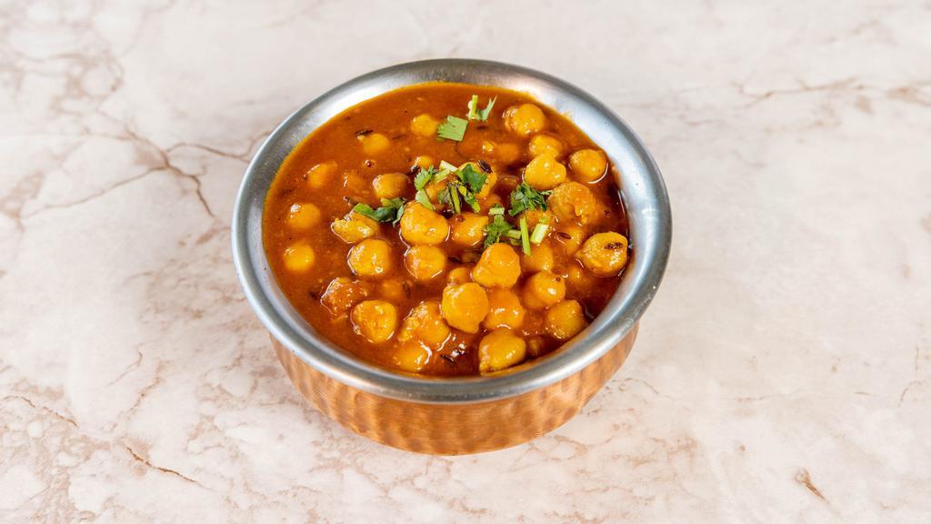 Chana Masala · Chickpeas cooked with tomato curry sauce and a blend of spices.