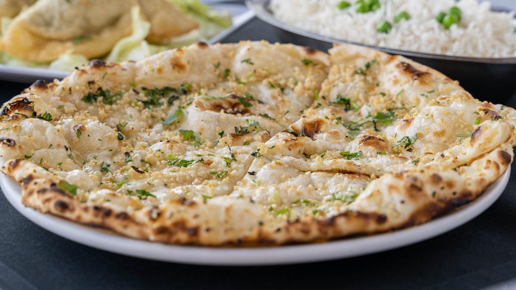 Garlic Naan · Naan with a subtle touch of garlic.
