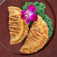 Empanadas · Delicious, crispy turnovers filled with shredded chicken or beef. Includes sauce.