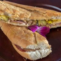 El Cubano · Delicious black forest ham, roasted pork, swiss cheese, pickles and mustard sauce on buttery...