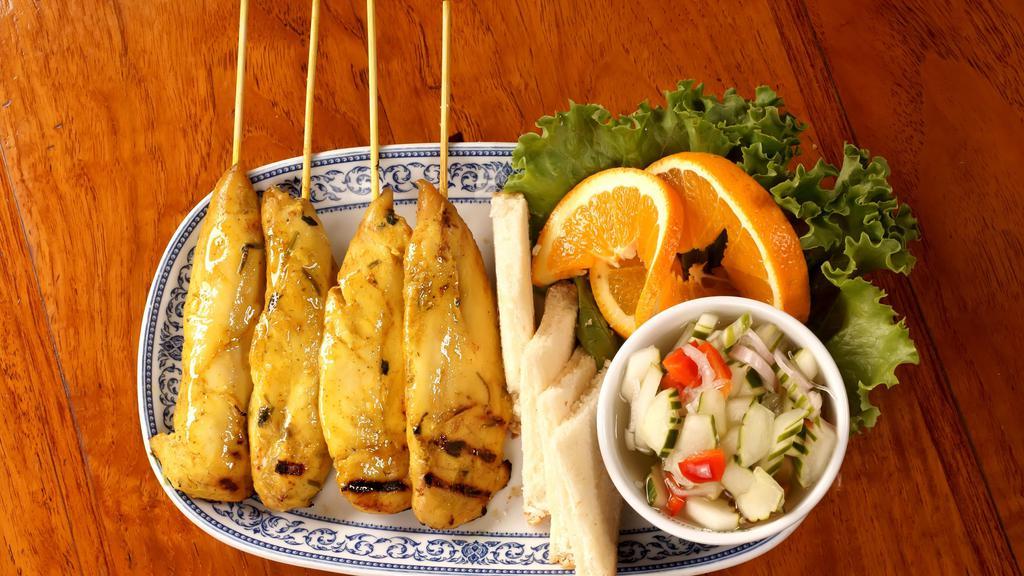 Chicken Satay · Four pieces. Chicken marinated in thai grilles sauce on skewers and served with peanut sauce and cucumber sauce.