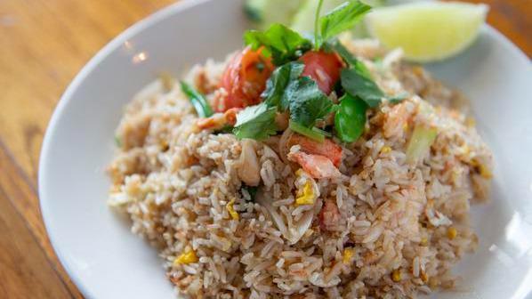 Crab Fried Rice · Fried rice with crab meat, egg, tomatoes, carrots, green peas, and onions.