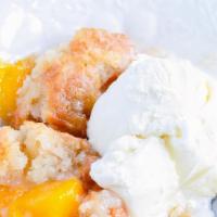 Classic Peach Cobbler · Vanilla bean ice cream, caramel, fresh whipped cream.