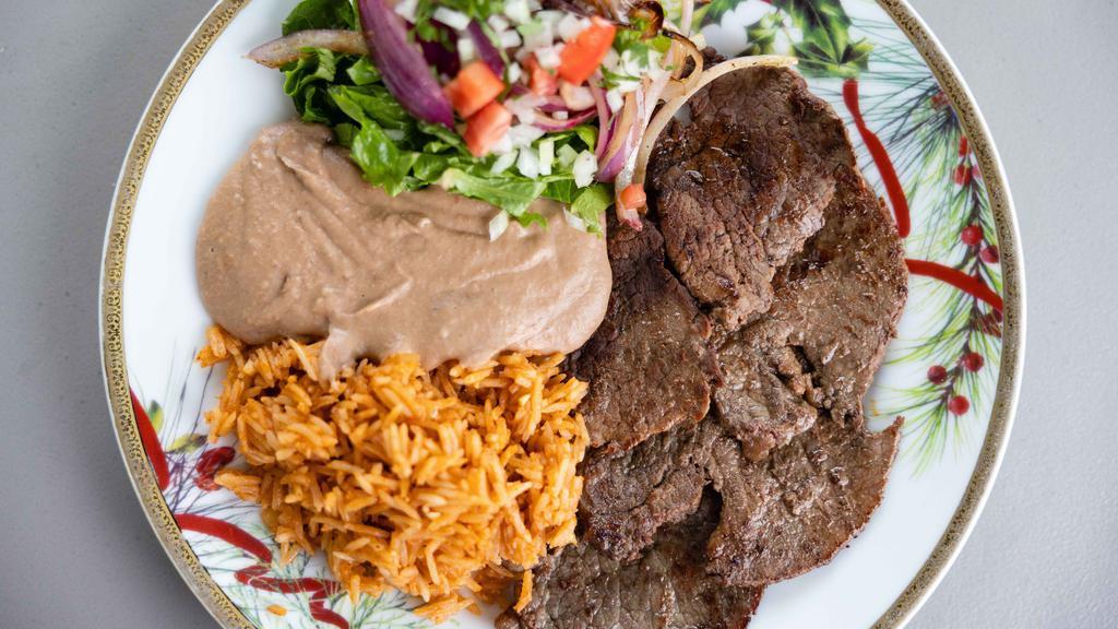 Carne Asada Plate · Carne asada served with refried beans, rice, pico de gallo, and a side of corn tortillas.