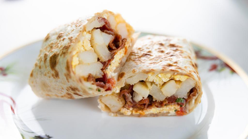 Spanish Breakfast Burrito · Flour tortilla with refried beans, rice, egg, potatoes, sour cream, cheese, pico de gallo, and choice of protein.