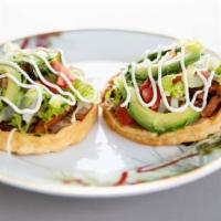 Sopes · Favorite. Two thick, fried tortillas (sopes) with beans, cheese, and choice of protein toppe...