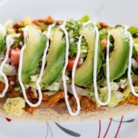 Huarache · Thick corn tortilla topped with beans, lettuce, tomato, avocado, sour cream, cheese and choi...