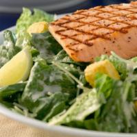 Caesar Salad With Grilled Wild Alaskan Salmon · Wild Alaskan Salmon Filet served on a Caesar Salad with croutons, Parmesan Cheese and Caesar...