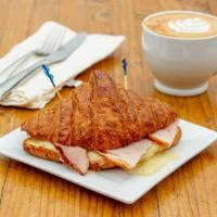 Ham, Egg, & Cheese Croissant · Smoked carved ham, Swiss cheese, egg soufflé, and bechamel sauce on a croissant.
