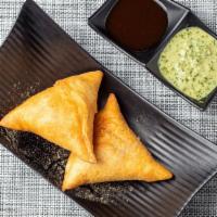 Vegetable Samosa  · A pastry of Vedic origin filled with spiced potatoes & onions.
