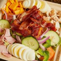 Cobb Salad · Eggs, Bacon, Ham, Turkey, Egg, cucumber, onions, cheese, tomatoes, lettuce and choice of one...