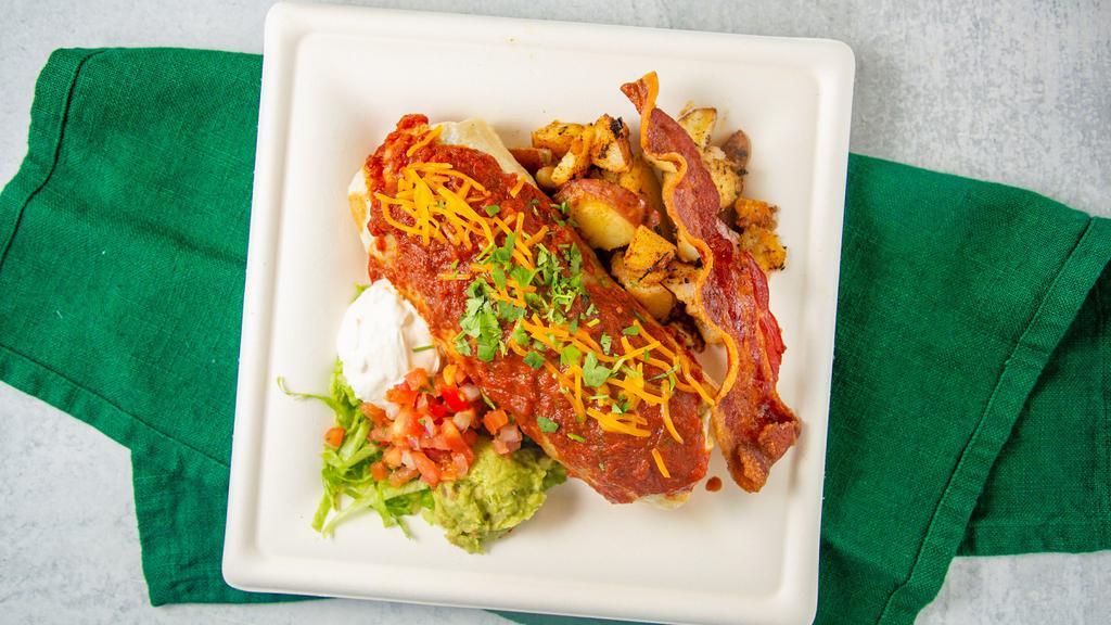 Breakfast Burrito · Scrambled eggs, black beans, skillet potatoes, pico de gallo, bacon, and cheese. Served enchilada style with a side of skillet potatoes, sour cream, and guacamole.