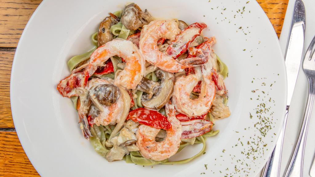 Shrimp Luisa · A delicious blend of mushrooms, roasted tomatoes, garlic, herbs and shrimp in a white wine cream sauce, served over spinach fettuccine.