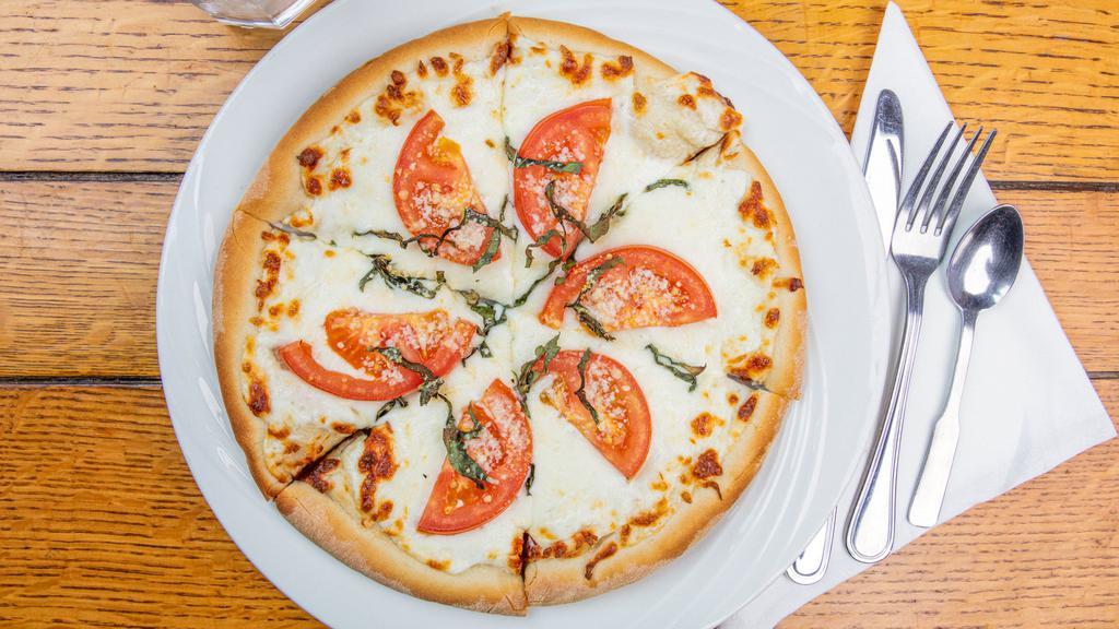 Pizza Marguerite · Mozzarella and parmesan cheese, sliced tomatoes, and basil.