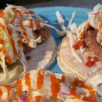 Hawaiian Beer Battered Fish Tacos W/Housemade Coleslaw And Tobasco Sriracha · Flaky Hawaiian white fish wrapped in a tortilla and topped with a spicy Tabasco infused srir...