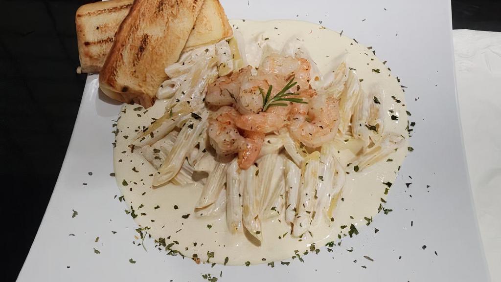 Shrimp Alfredo · Fresh shrimp sautéed in garlic butter, tossed in a house-made Alfredo sauce, and poured over a bed of penne noodles. Includes Garlic Bread and choice of Side Salad.
