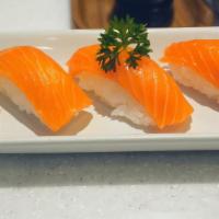 Salmon Sushi · 8 pieces of raw  salmon on seasoned rice and one tuna roll