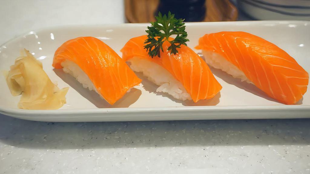 Salmon Sushi · 8 pieces of raw  salmon on seasoned rice and one tuna roll
