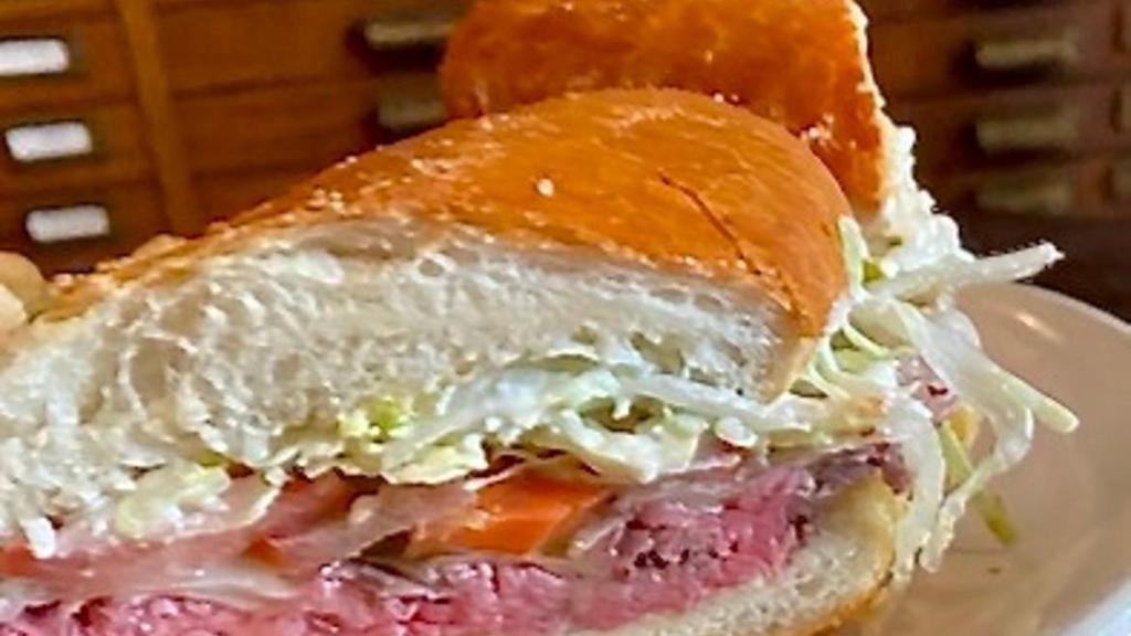 Italian Beef · garlic & herb roasted beef, swiss cheese, giardiniera (chicago-style pickled peppers), tomato, lettuce & horseradish mayo on a grinder roll