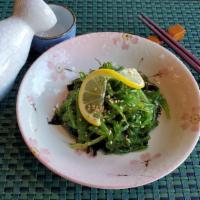 Seaweed Salad · Green leafy seaweed and wakame seaweed, Garnished with lemon.