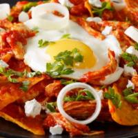 Chilaquiles · Fried corn tortilla strips topped with tomatillo salsa, cheese and sour cream, served with t...